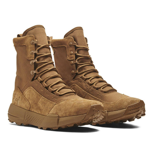 Pair of Under Armour Loadout military boots in coyote (dark brown) on a white background, shown in a front three-quarter view with suede overlays, lace-up design, and rugged outsoles visible.