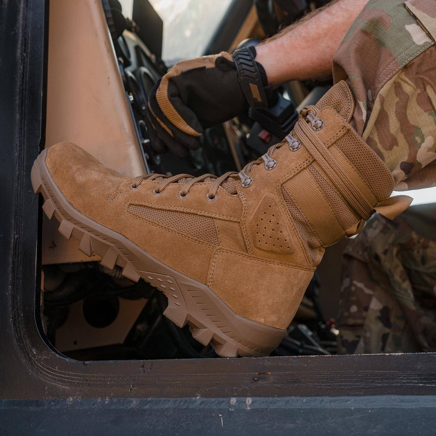 Coyote tactical boot on foot inside vehicle cab, showing side mesh panel and thick lug sole